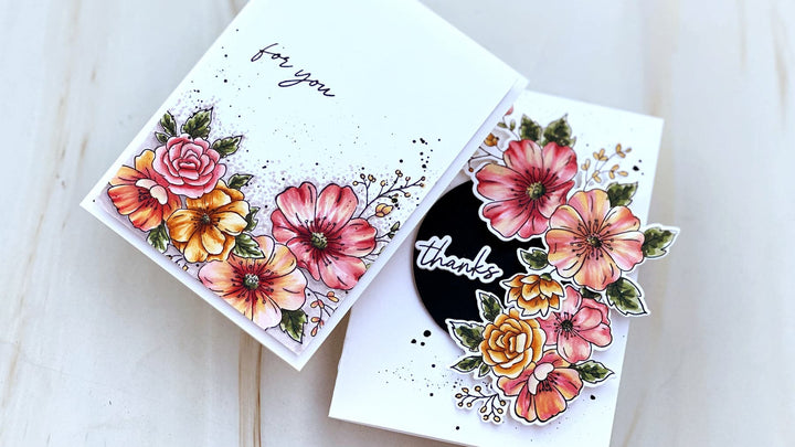 Close up of Charming Clusters flowers showing two tone flowers in pink and yellow with dark centers and ink splatter accents